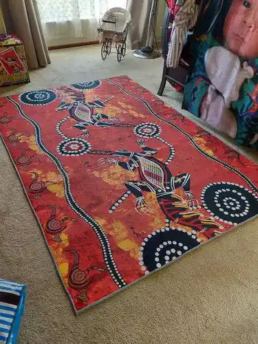 Colorful elephant design rug on a carpeted floor with furniture in the background