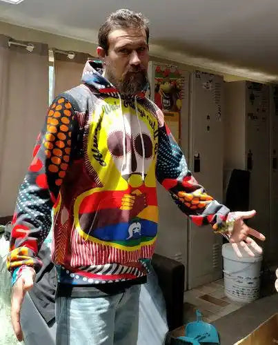 Person wearing a colorful hoodie in an indoor setting