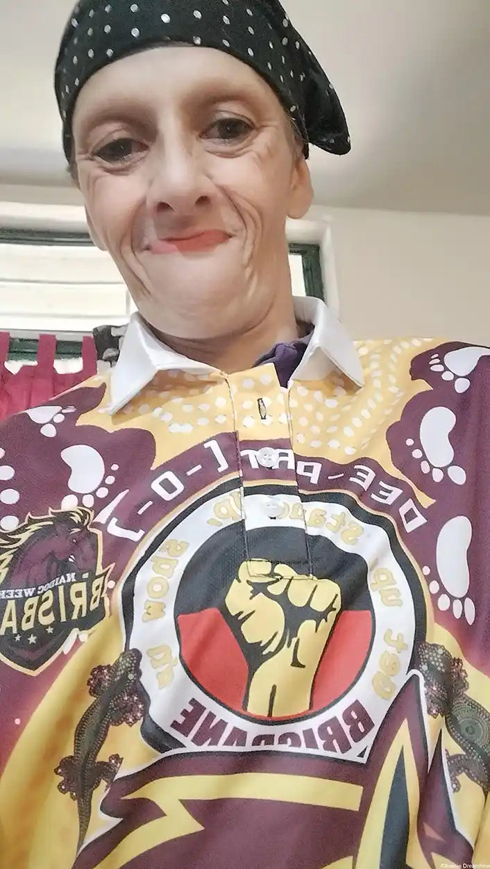 Person wearing a colorful shirt with logos and text