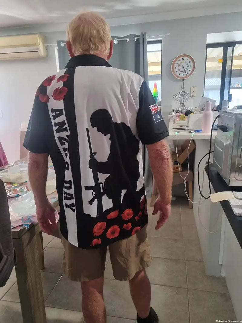 Person wearing a shirt with ANZAC Day design in a kitchen.