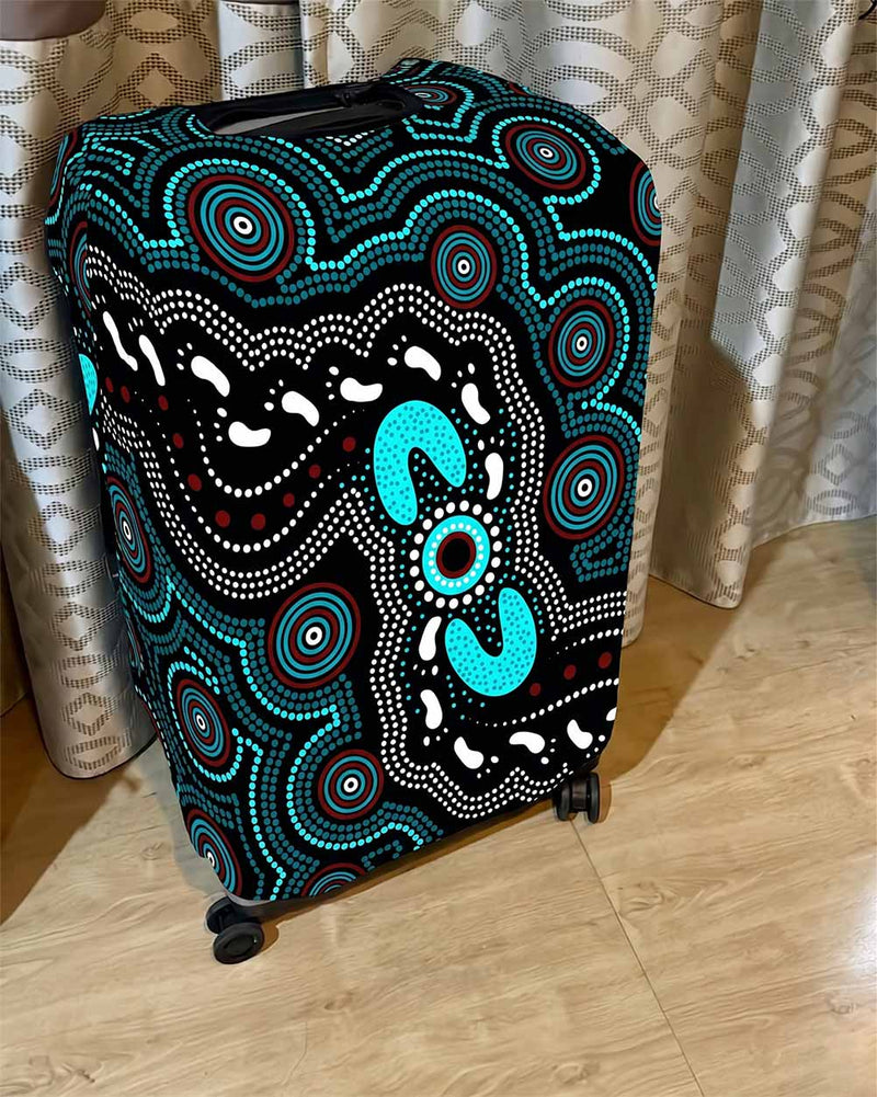 Luggage with Aboriginal art design on a wooden floor