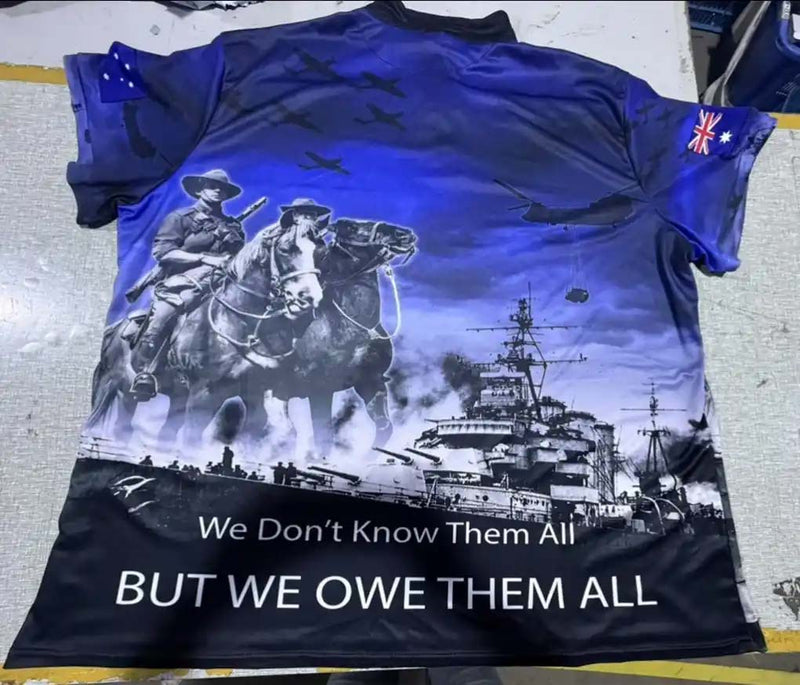 T-shirt with a graphic design of soldiers on horses and a ship, with text 'We Don't Know Them All BUT WE OWE THEM ALL'.