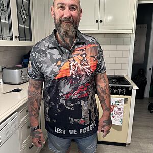 Man wearing a graphic t-shirt in a kitchen