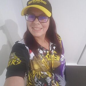 Person wearing a sports team jersey and cap indoors