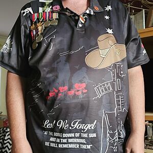 Person wearing a black polo shirt with military-themed graphics and text.