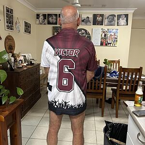 Man wearing a sports jersey with the name 'Victor' and number '6' in a home setting.
