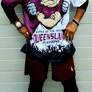 Person wearing a graphic t-shirt with a design and text, standing against a plain background.