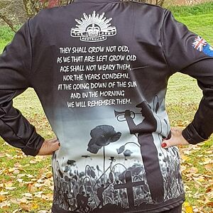 Person wearing a hoodie with a graphic design on the back, featuring text and images.