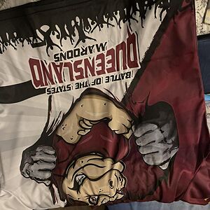 Product with graphic design featuring a stylized face and text on a white and red background