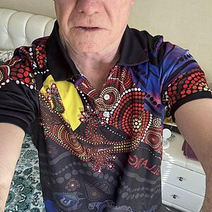 Person wearing a colorful patterned shirt with a blurred background